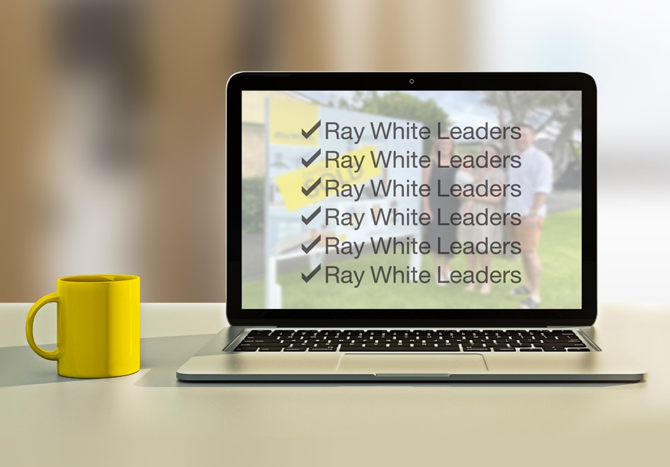 Ray White Leaders - open laptop with yellow coffee cup